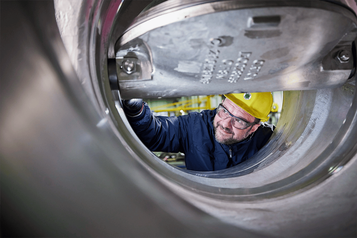 IMI Orton engineer meticulously inspects gate valve at facility, ensuring reliability, safety, and performance of their high-quality valves