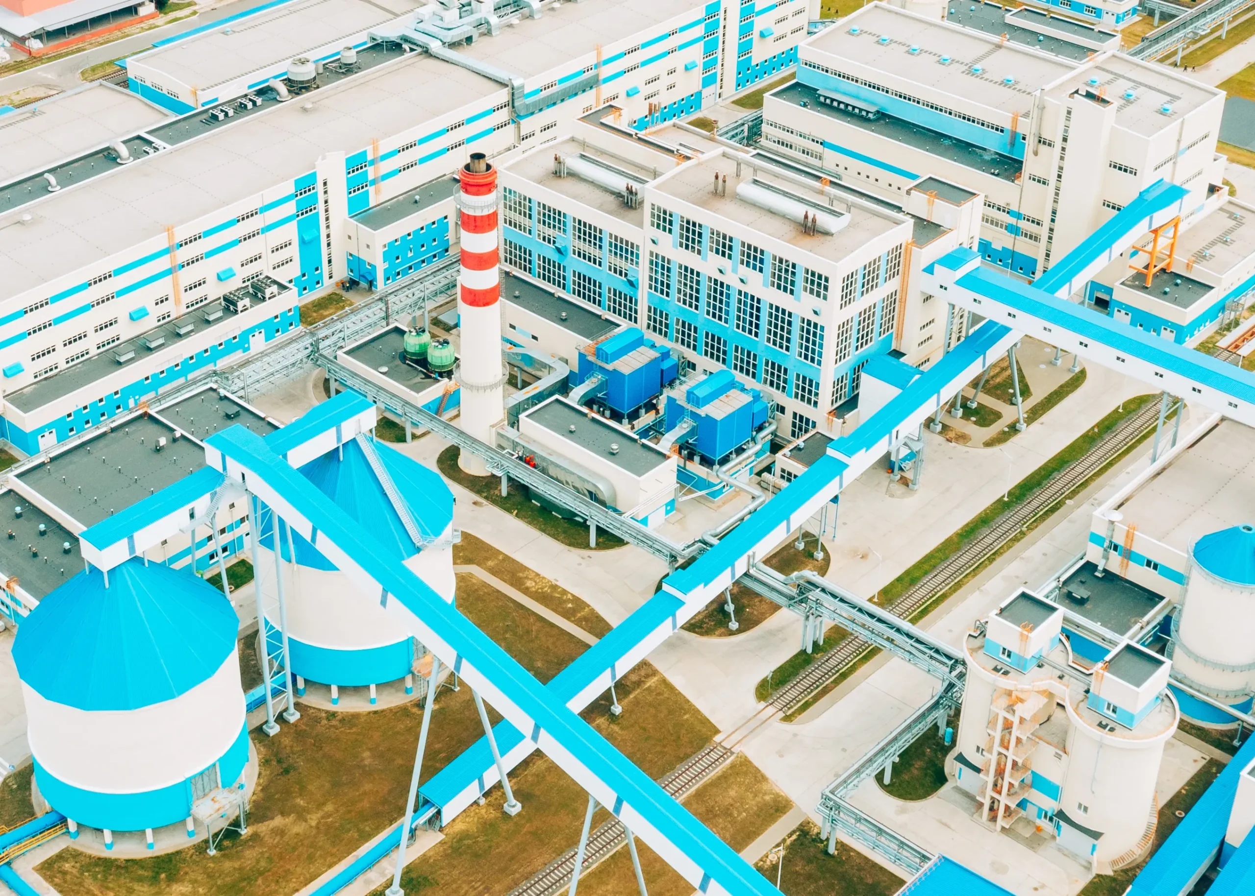 Marvel at the harmonious integration of valve technology in a contemporary paper mill—aerially capturing its enhanced operations and optimised efficiency on a sunny summer day