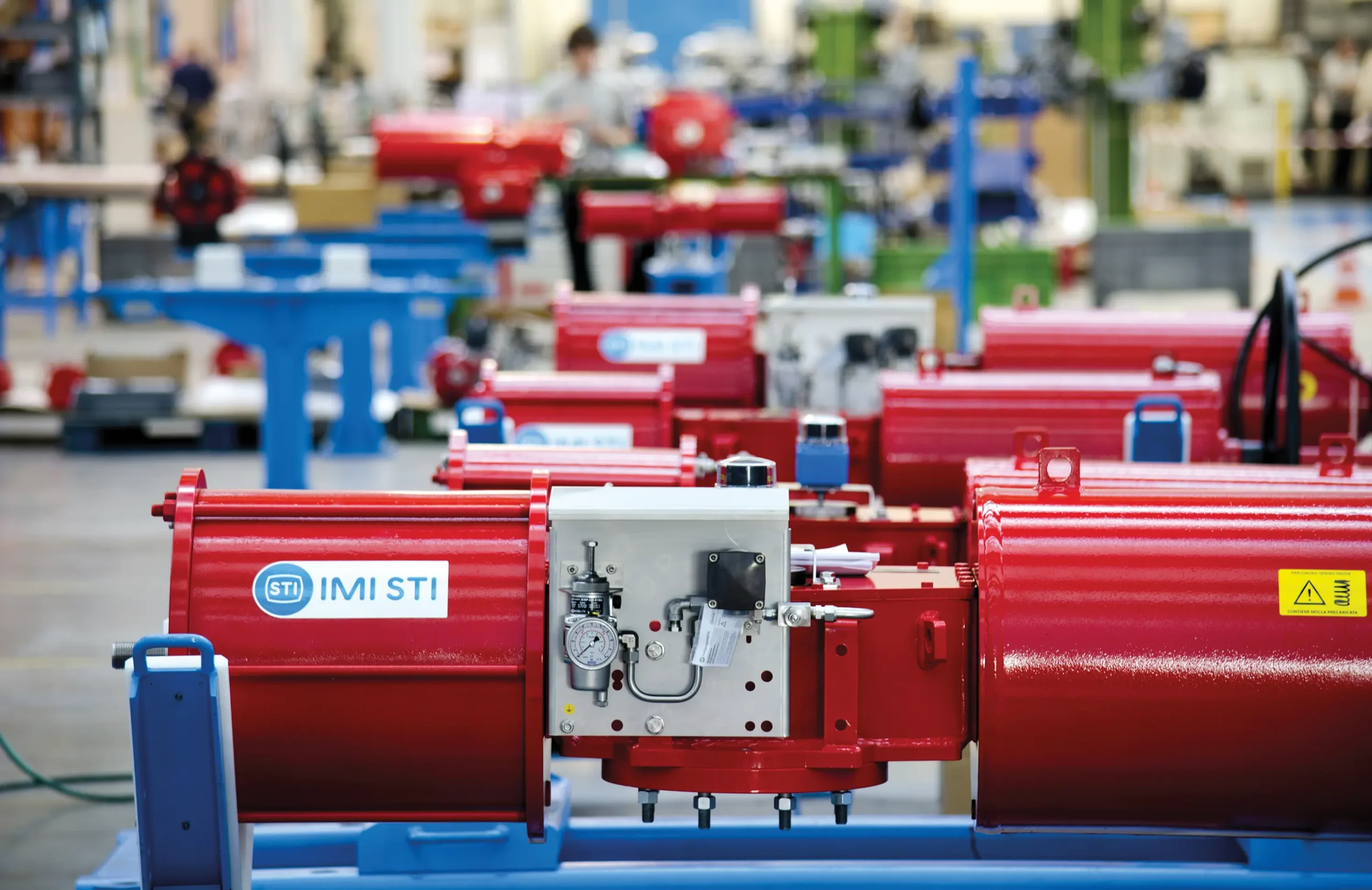 Vibrant red actuators await packaging and shipping at IMI STI facility, ready to power valves worldwide with their reliable precision.
