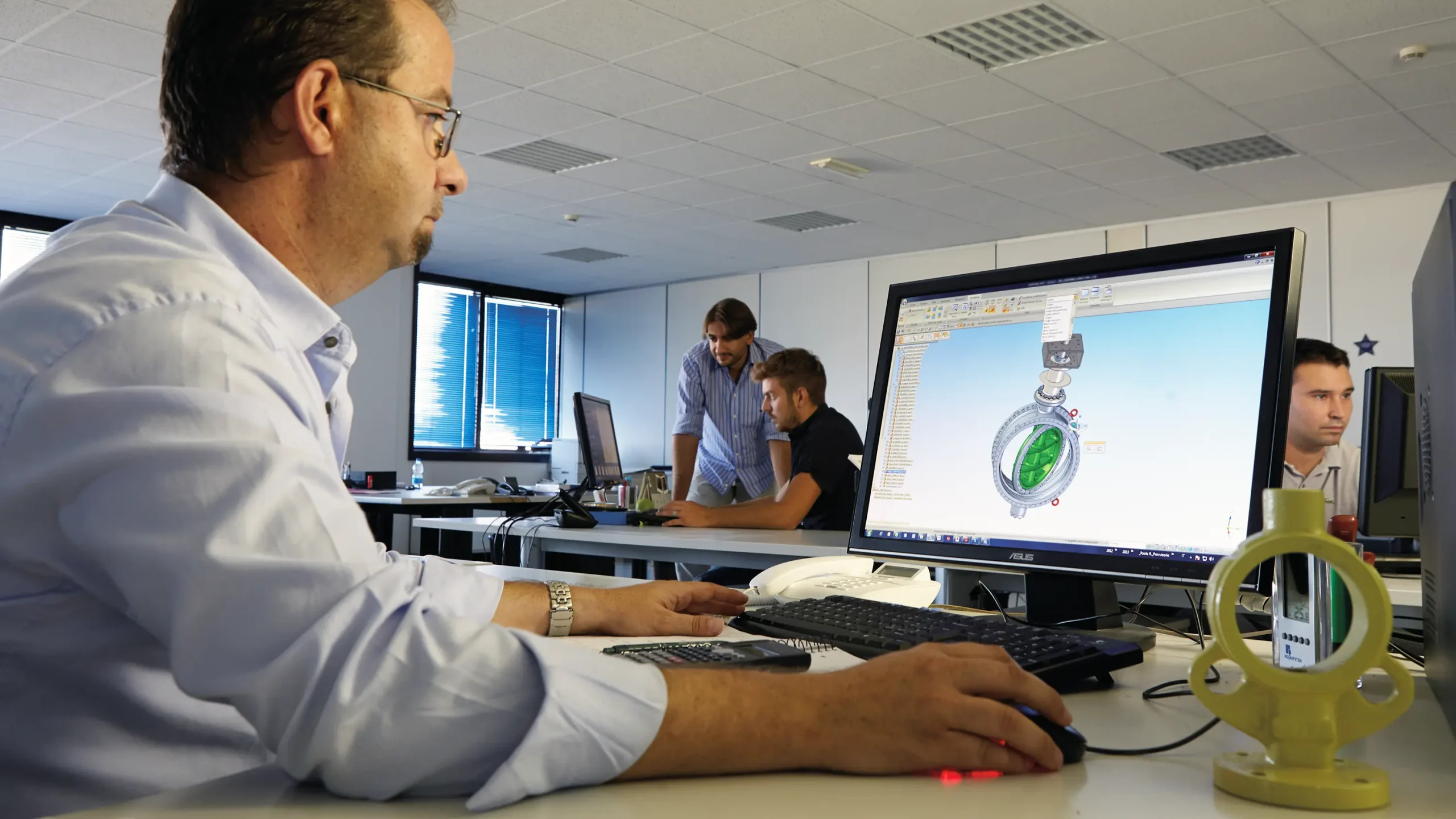 IMI Orton engineer using cutting-edge software to design a triple eccentric butterfly valve, showcasing precision engineering at their Italy site.